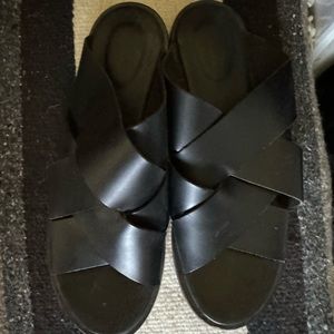 Black Clark’s slip on leather sandals.